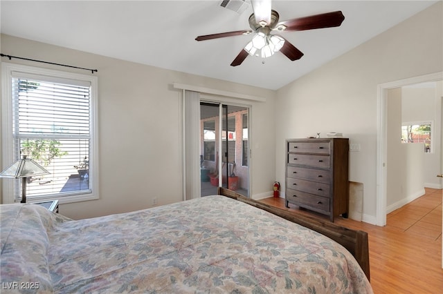 bedroom featuring lofted ceiling, wood finished floors, access to outside, baseboards, and a ceiling fan