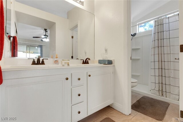 5900 Red Umber Ave, Las Vegas, NV 89130 - bathroom featuring double vanity, a ceiling fan, tile patterned flooring, a shower with curtain, and healthy amount of natural light