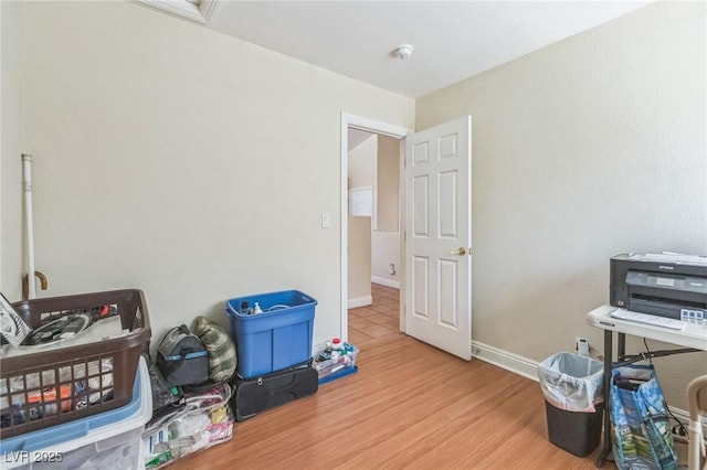 misc room with baseboards and wood finished floors
