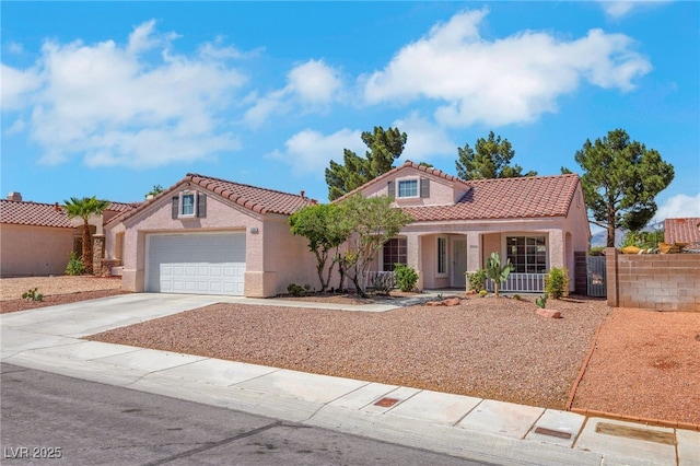 mediterranean / spanish home featuring a tiled roof, a garage, fence, concrete driveway, and stucco siding