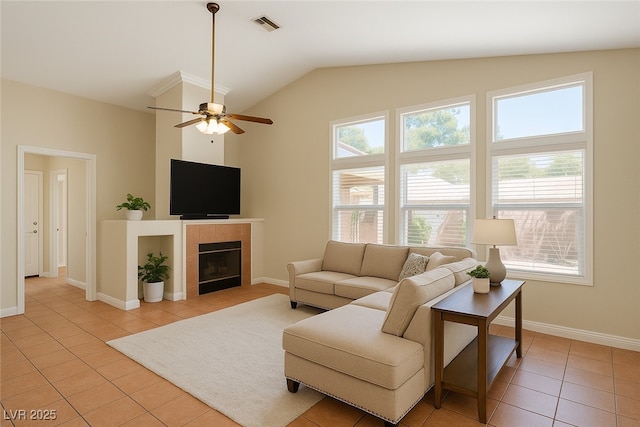 5900 Red Umber Ave, Las Vegas, NV 89130 - living room featuring light tile patterned floors, vaulted ceiling, a ceiling fan, and a tile fireplace