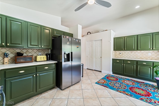 kitchen featuring light countertops, green cabinetry, and stainless steel fridge