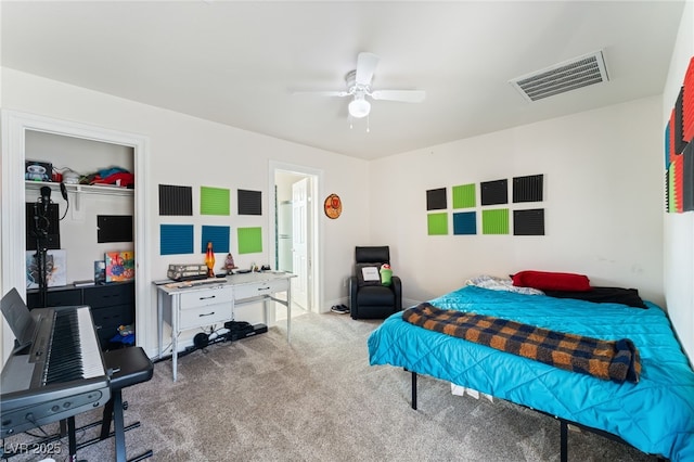carpeted bedroom featuring ceiling fan, a closet, and visible vents