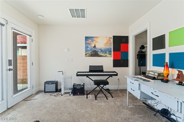 office area with carpet floors, baseboards, and visible vents