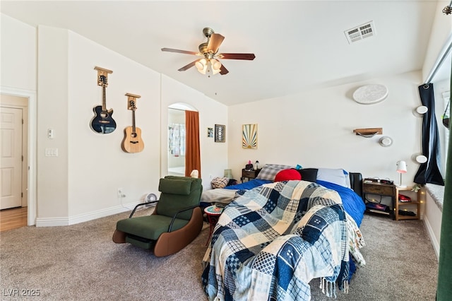 carpeted bedroom featuring visible vents, a ceiling fan, lofted ceiling, baseboards, and arched walkways