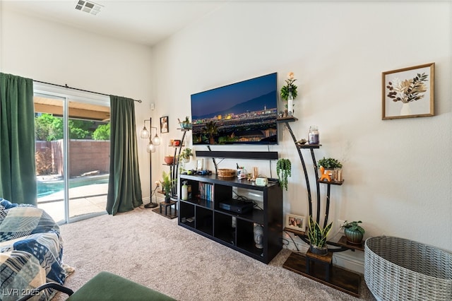 carpeted living area with baseboards and visible vents