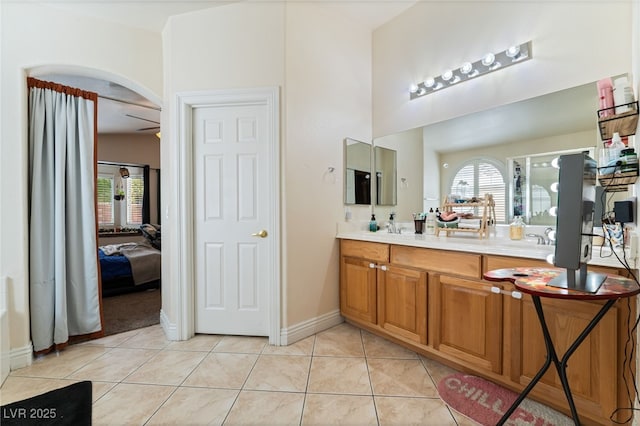 full bath featuring tile patterned flooring, double vanity, and plenty of natural light