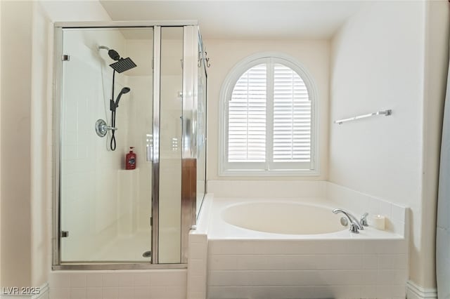 bathroom with a shower stall and a bath