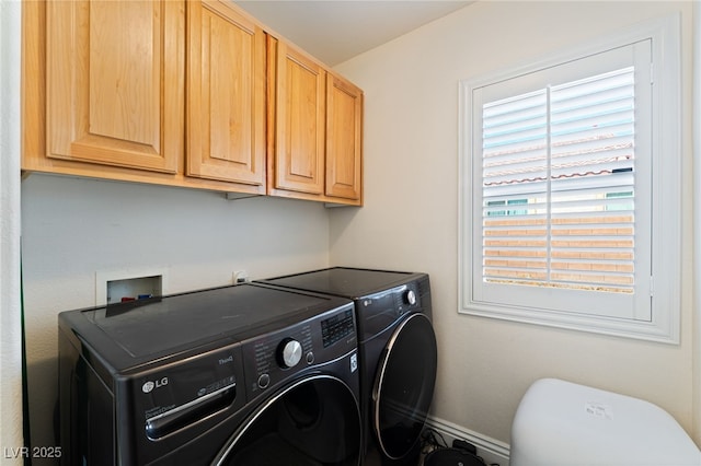 clothes washing area with baseboards, cabinet space, and washer and clothes dryer