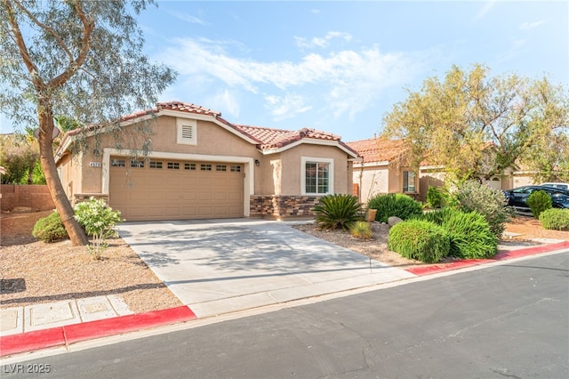 mediterranean / spanish house with a garage, stucco siding, a tiled roof, and concrete driveway