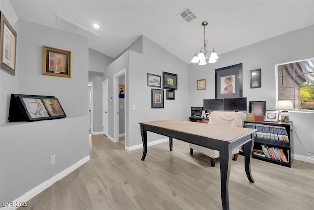 office with visible vents, an inviting chandelier, light wood-style floors, baseboards, and vaulted ceiling