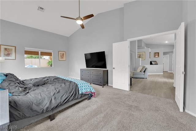 carpeted bedroom featuring ceiling fan, high vaulted ceiling, visible vents, and baseboards