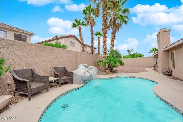 view of pool with a fenced in pool, a fenced backyard, and a patio area