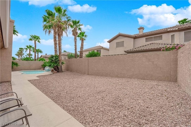 view of yard with a patio, a fenced in pool, and a fenced backyard