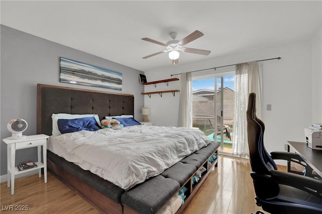bedroom featuring access to outside, light wood-style floors, and ceiling fan