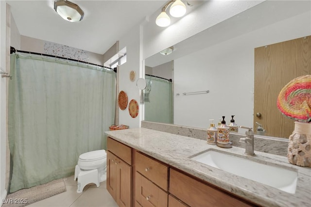 bathroom featuring vanity, a shower with shower curtain, tile patterned floors, and toilet