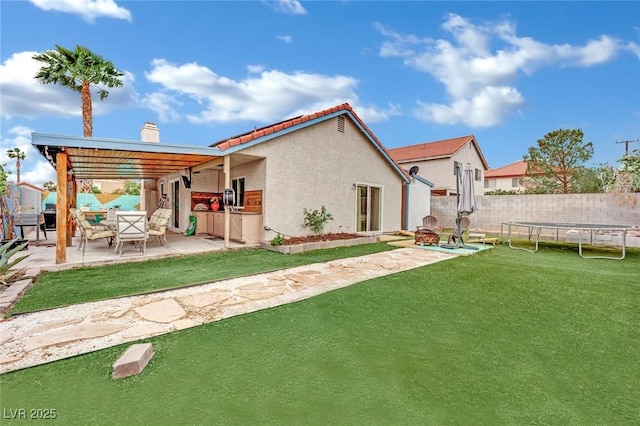 back of house featuring a fenced backyard, a patio, a chimney, and a yard
