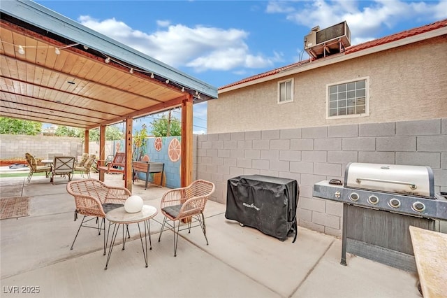 view of patio / terrace with outdoor dining area, a fenced backyard, and grilling area
