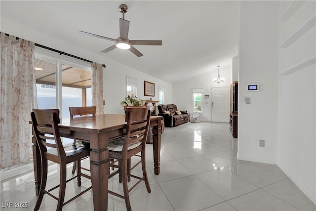 dining area featuring baseboards, vaulted ceiling, light tile patterned floors, and ceiling fan with notable chandelier
