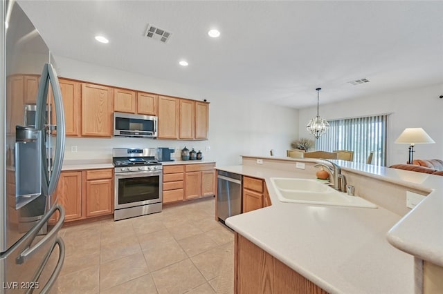 7908 House Sparrow St, North Las Vegas, NV 89084 - kitchen featuring visible vents, a sink, appliances with stainless steel finishes, and light countertops