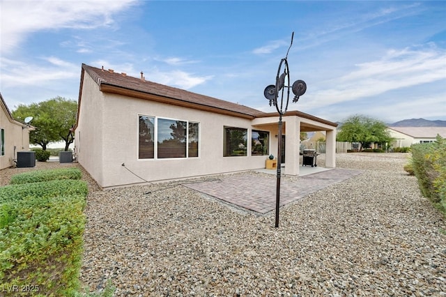 7908 House Sparrow St, North Las Vegas, NV 89084 - rear view of house featuring stucco siding, central air condition unit, and a patio