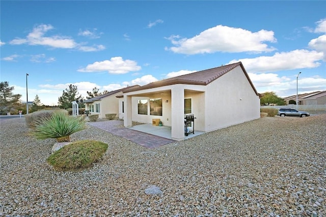 7908 House Sparrow St, North Las Vegas, NV 89084 - rear view of property featuring stucco siding and a patio area