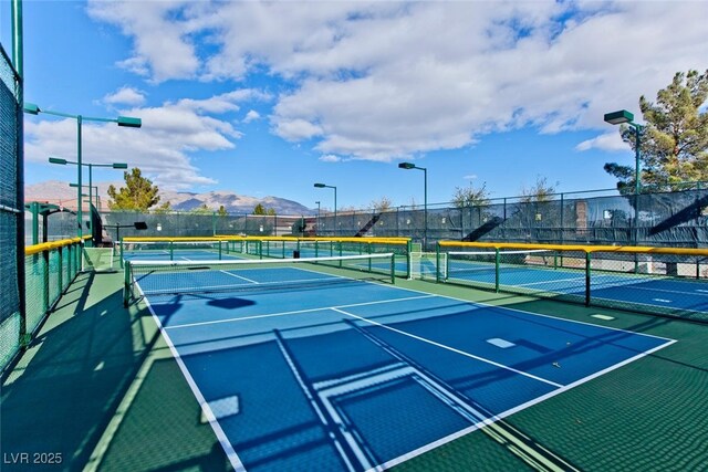 7908 House Sparrow St, North Las Vegas, NV 89084 - view of tennis court with fence and a mountain view