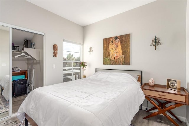 bedroom with a closet and wood finished floors