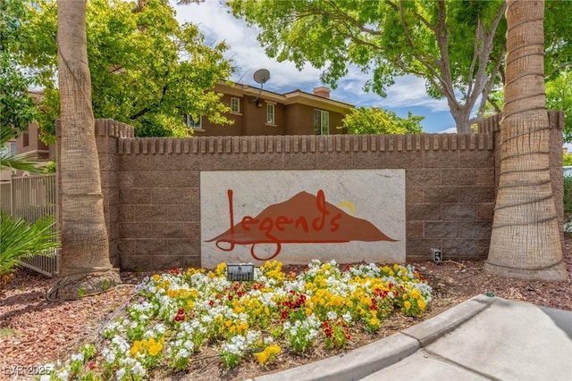 community / neighborhood sign with fence
