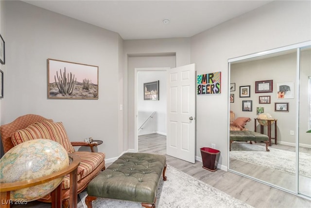 living area with baseboards and light wood finished floors
