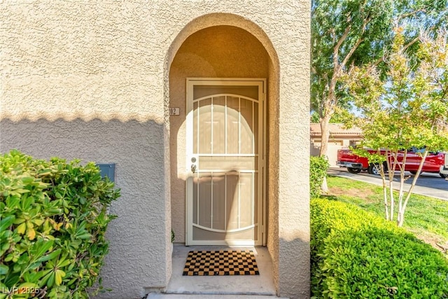 doorway to property with stucco siding
