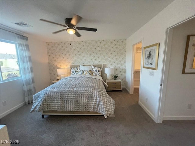 bedroom with wallpapered walls, visible vents, and carpet