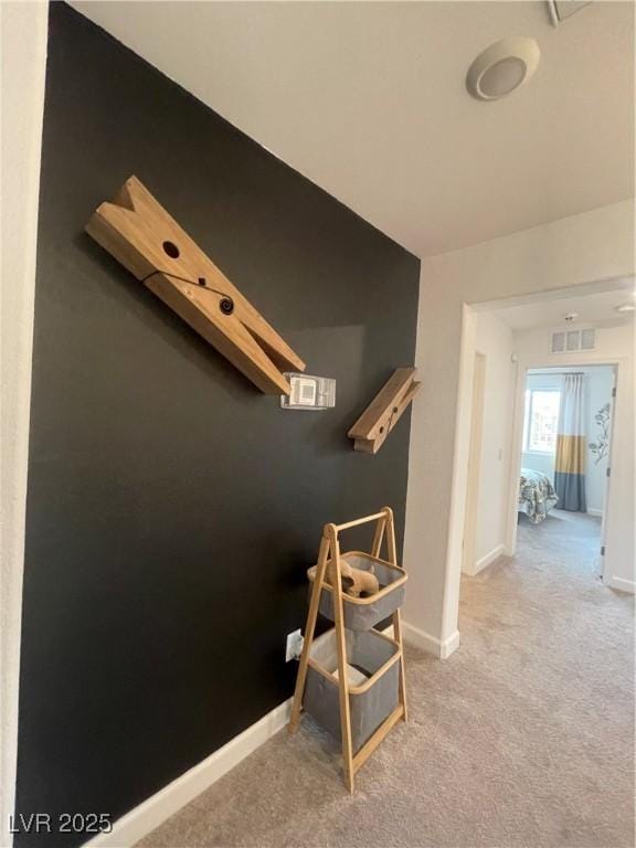 interior space featuring carpet floors, baseboards, and visible vents