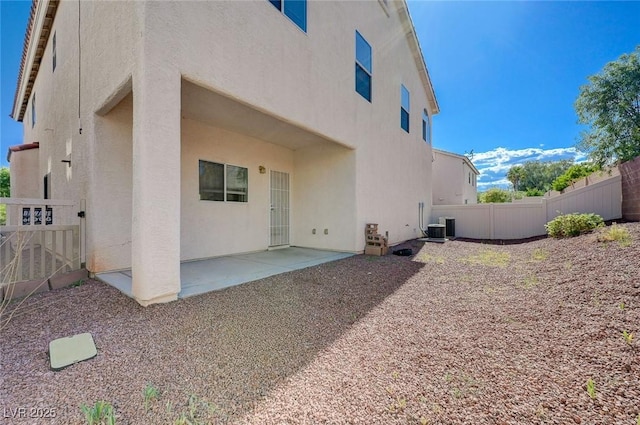 back of house featuring a patio, stucco siding, and fence