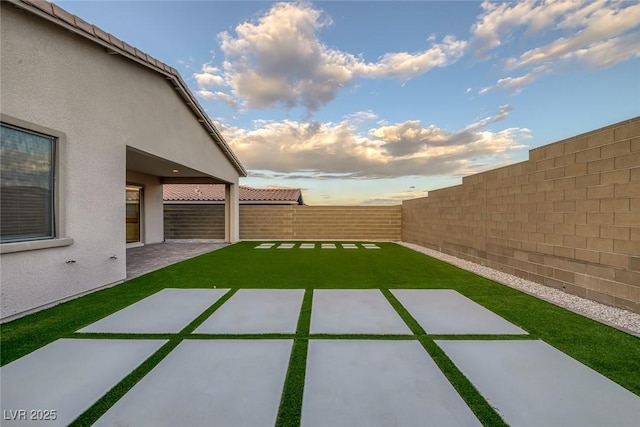 view of yard with a fenced backyard and a patio area