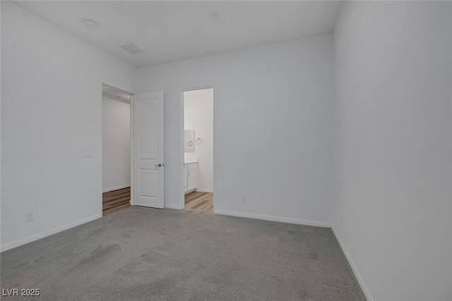 unfurnished room with baseboards, carpet, and visible vents