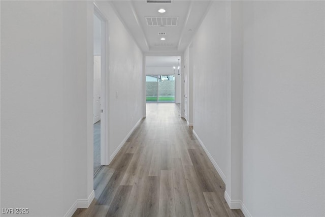 hall featuring visible vents, recessed lighting, baseboards, and wood finished floors