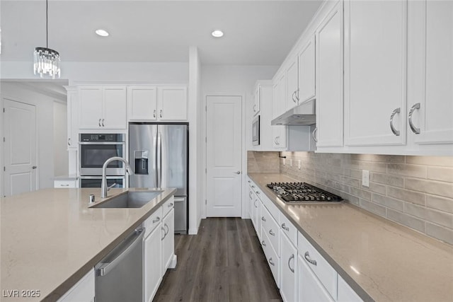 kitchen with a sink, white cabinetry, appliances with stainless steel finishes, and under cabinet range hood