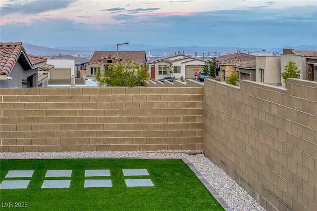 view of yard featuring a residential view and fence