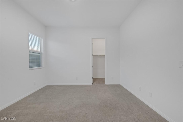 carpeted empty room featuring baseboards