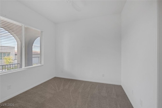 empty room with baseboards, carpet, and a ceiling fan