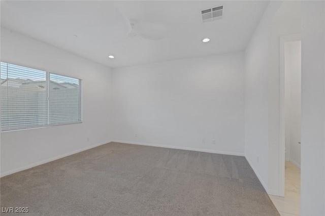 empty room with visible vents, recessed lighting, baseboards, and light colored carpet