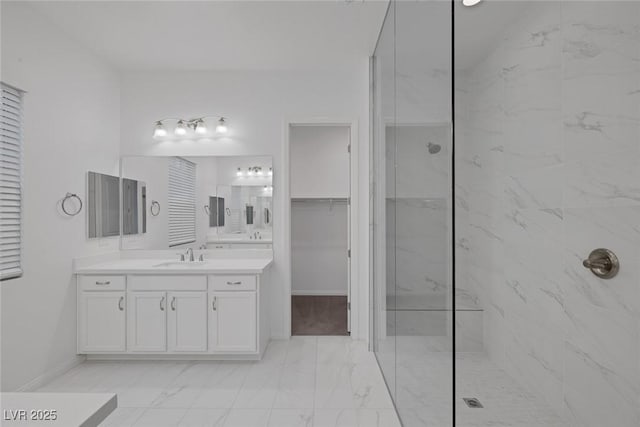 full bathroom with vanity, marble finish floor, baseboards, and a marble finish shower