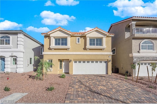 6142 Kelson Creek Ct, Las Vegas, NV 89118 - view of front of house with decorative driveway, a garage, stucco siding, and a tiled roof