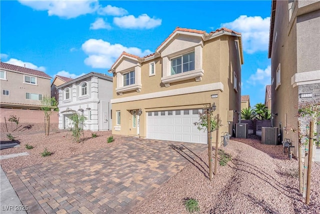 6142 Kelson Creek Ct, Las Vegas, NV 89118 - traditional home featuring an attached garage, stucco siding, cooling unit, decorative driveway, and a tiled roof