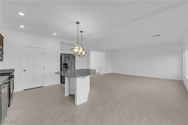 6142 Kelson Creek Ct, Las Vegas, NV 89118 - kitchen with a breakfast bar area, a kitchen island, dark stone counters, stainless steel appliances, and recessed lighting