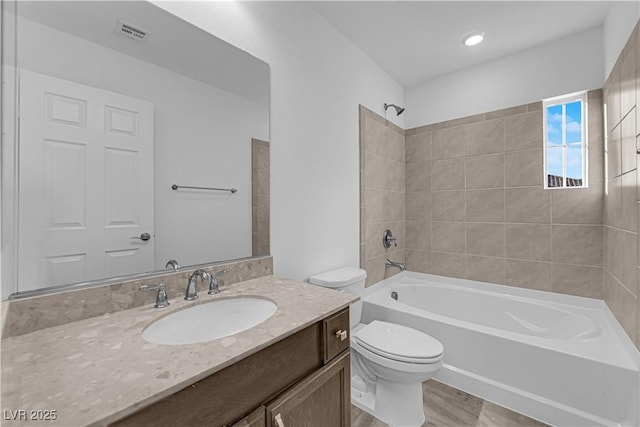 6142 Kelson Creek Ct, Las Vegas, NV 89118 - bathroom with visible vents, vanity, wood finished floors, toilet, and shower / washtub combination