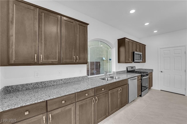 6142 Kelson Creek Ct, Las Vegas, NV 89118 - kitchen featuring dark brown cabinets, light stone countertops, recessed lighting, a sink, and appliances with stainless steel finishes