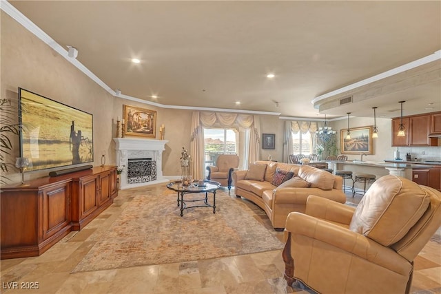 living area with crown molding, recessed lighting, and a fireplace