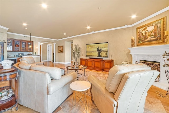 living area featuring recessed lighting, ornamental molding, ornate columns, and a fireplace